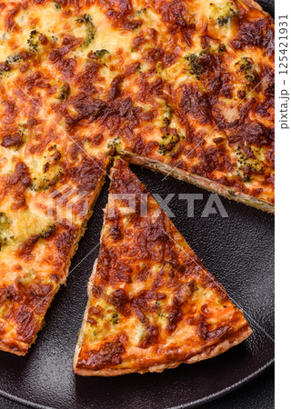 Delicious fresh quiche with broccoli, cheese, spices and herbs Delicious fresh quiche with broccoli, cheese, spices and herbs 125421931