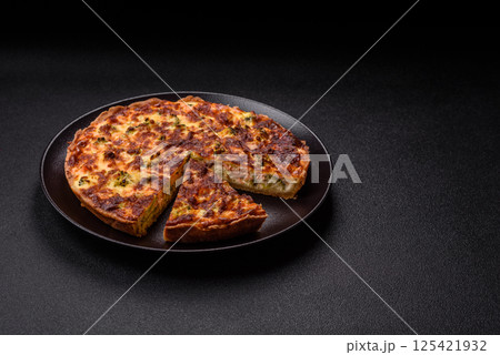Delicious fresh quiche with broccoli, cheese, spices and herbs 125421932
