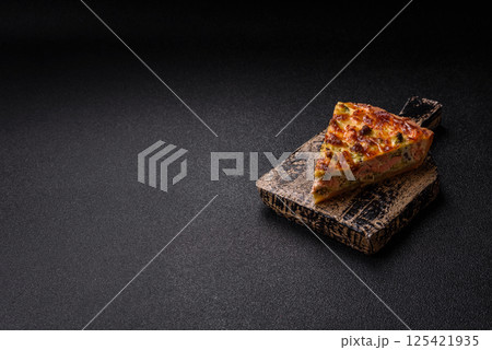 Delicious fresh quiche with broccoli, cheese, spices and herbs 125421935