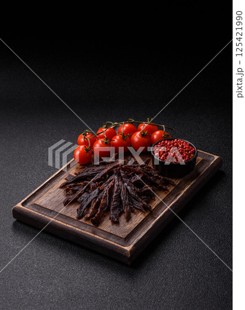 Jerky, dried horse meat or beef slices with salt and spices 125421990