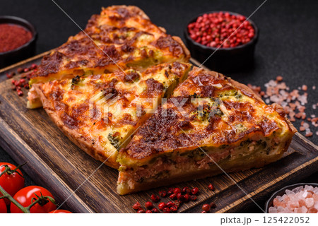 Delicious fresh quiche with broccoli, cheese, spices and herbs 125422052