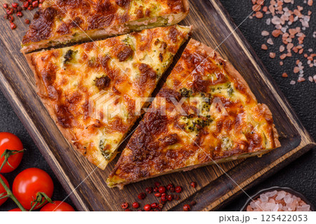 Delicious fresh quiche with broccoli, cheese, spices and herbs Delicious fresh quiche with broccoli, cheese, spices and herbs 125422053