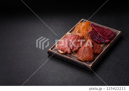 Jerky, dried pork meat with salt and spices 125422211