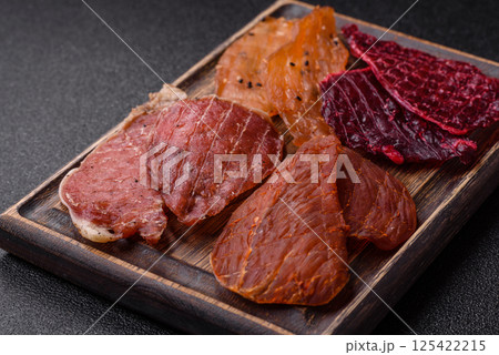 Jerky, dried pork meat with salt and spices 125422215