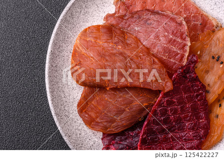 Jerky, dried pork meat with salt and spices 125422227