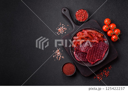 Dried beef slices, jerky, with cherry or plum flavor, salt and spices Dried beef slices, jerky, with cherry or plum flavor, salt and spices 125422237