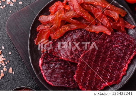 Dried beef slices, jerky, with cherry or plum flavor, salt and spices 125422241