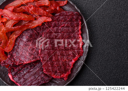 Dried beef slices, jerky, with cherry or plum flavor, salt and spices Dried beef slices, jerky, with cherry or plum flavor, salt and spices 125422244