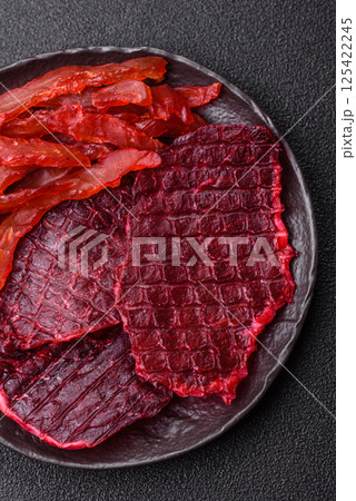 Dried beef slices, jerky, with cherry or plum flavor, salt and spices 125422245