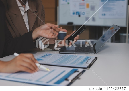 Accounting company provide finance and taxation planning for profitable cash flow, Auditor and accountant team working in office, analyze financial data and accounting record with calculator.Insight Accounting company provide finance and taxation planning for profitable cash flow, Auditor and accountant team working in office, analyze financial data and accounting record with calculator.Insight 125422857