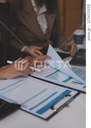 Accounting company provide finance and taxation planning for profitable cash flow, Auditor and accountant team working in office, analyze financial data and accounting record with calculator.Insight Accounting company provide finance and taxation planning for profitable cash flow, Auditor and accountant team working in office, analyze financial data and accounting record with calculator.Insight 125422858