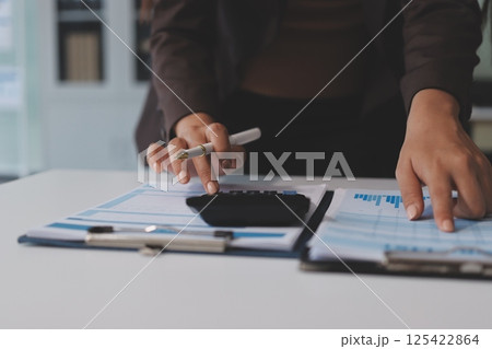Accounting company provide finance and taxation planning for profitable cash flow, Auditor and accountant team working in office, analyze financial data and accounting record with calculator.Insight Accounting company provide finance and taxation planning for profitable cash flow, Auditor and accountant team working in office, analyze financial data and accounting record with calculator.Insight 125422864