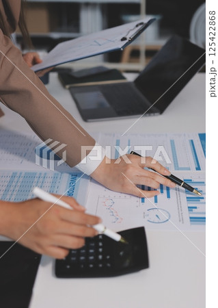 Accounting company provide finance and taxation planning for profitable cash flow, Auditor and accountant team working in office, analyze financial data and accounting record with calculator.Insight Accounting company provide finance and taxation planning for profitable cash flow, Auditor and accountant team working in office, analyze financial data and accounting record with calculator.Insight 125422868