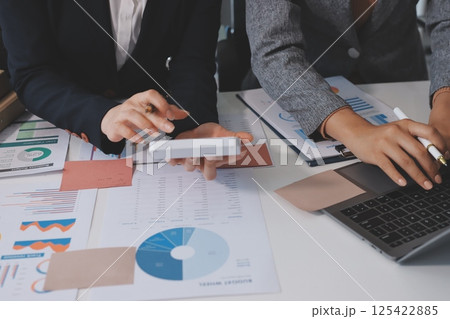 Accounting company provide finance and taxation planning for profitable cash flow, Auditor and accountant team working in office, analyze financial data and accounting record with calculator.Insight 125422885