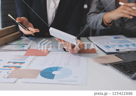 Accounting company provide finance and taxation planning for profitable cash flow, Auditor and accountant team working in office, analyze financial data and accounting record with calculator.Insight 125422886