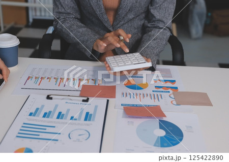 Accounting company provide finance and taxation planning for profitable cash flow, Auditor and accountant team working in office, analyze financial data and accounting record with calculator.Insight Accounting company provide finance and taxation planning for profitable cash flow, Auditor and accountant team working in office, analyze financial data and accounting record with calculator.Insight 125422890