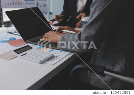 Accounting company provide finance and taxation planning for profitable cash flow, Auditor and accountant team working in office, analyze financial data and accounting record with calculator.Insight 125422891