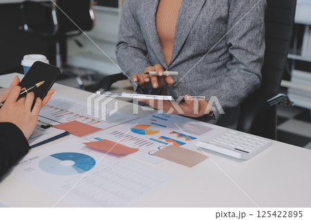 Accounting company provide finance and taxation planning for profitable cash flow, Auditor and accountant team working in office, analyze financial data and accounting record with calculator.Insight 125422895