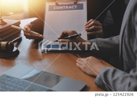 Judge gavel with Justice lawyers having team meeting at law firm background. Concepts of Law and Legal services. 125422926