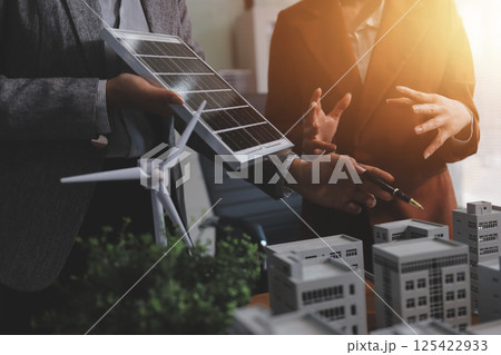 Discussion among businesspeople on the latest developments in solar cell panel technology and Solar Energy Environment city Concept. 125422933