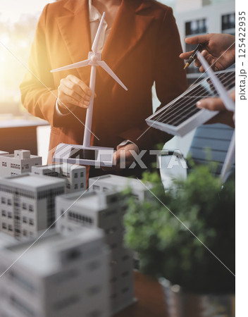 Discussion among businesspeople on the latest developments in solar cell panel technology and Solar Energy Environment city Concept. 125422935