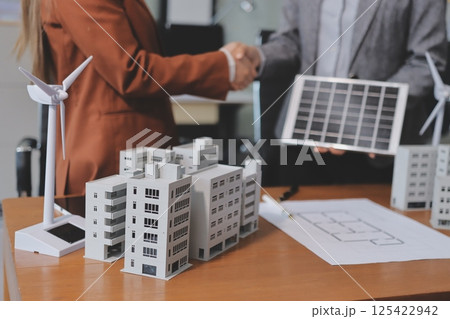 Discussion among businesspeople on the latest developments in solar cell panel technology and Solar Energy Environment city Concept. 125422942