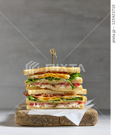 club sandwich on wooden cutting board 125423710