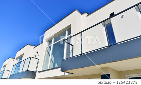 Terraced family homes in newly developed housing estate. The real estate market in the suburbs. New single family houses in a new development area. Residential homes with modern facade. Terraced family homes in newly developed housing estate. The real estate market in the suburbs. New single family houses in a new development area. Residential homes with modern facade. 125423878