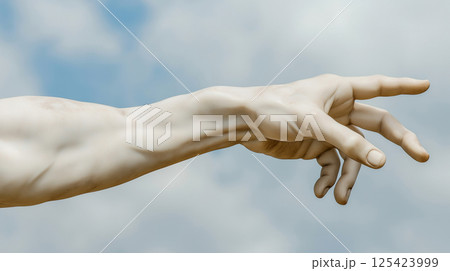Detailed view of marble hand against a cloudy sky 125423999