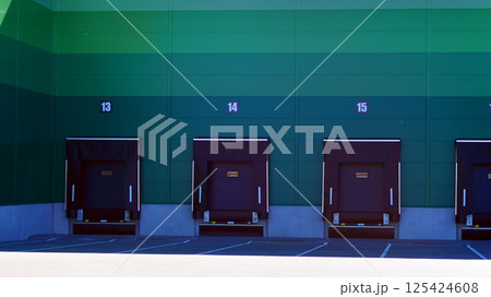Facade of an industrial building and warehouse. Empty platforms at a distribution center. Facade of an industrial building and warehouse. Empty platforms at a distribution center. 125424608