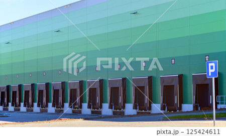 Facade of an industrial building and warehouse. Empty platforms at a distribution center. Facade of an industrial building and warehouse. Empty platforms at a distribution center. 125424611