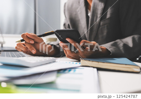 Working from home, Closeup business woman using laptop computer and analyzing financial report. Working from home, Closeup business woman using laptop computer and analyzing financial report. 125424787