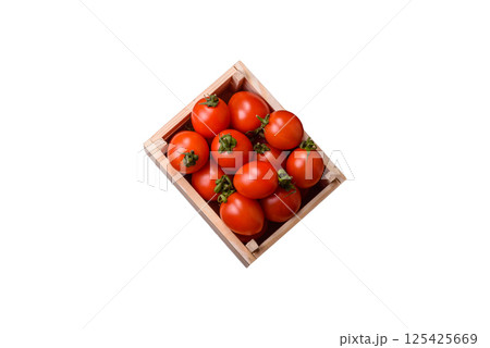 Ripe red cherry tomatoes in a wooden box 125425669