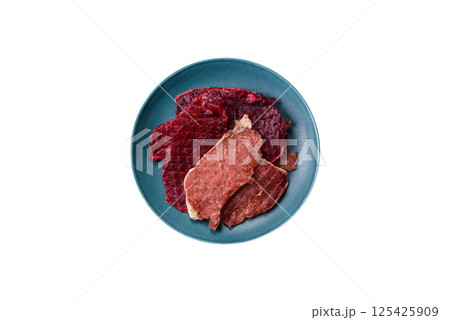 Jerky, dried pork meat slices with salt and spices Jerky, dried pork meat slices with salt and spices 125425909