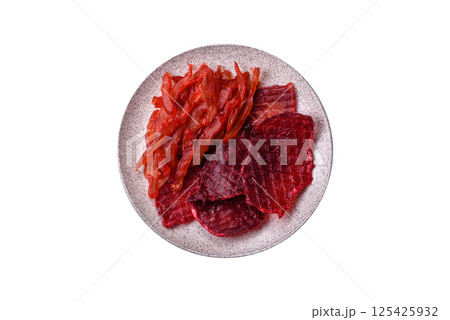 Dried beef slices, jerky, with cherry or plum flavor, salt and spices Dried beef slices, jerky, with cherry or plum flavor, salt and spices 125425932