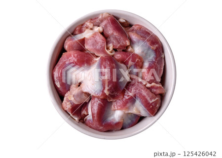 Raw chicken or turkey gizzards with salt, spices and herbs 125426042