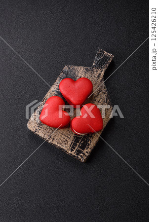 Red macaroons in the shape of a heart, sweets for the holiday of Valentine's Day Red macaroons in the shape of a heart, sweets for the holiday of Valentine's Day 125426210