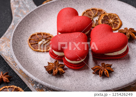 Red macaroons in the shape of a heart, sweets for the holiday of Valentine's Day Red macaroons in the shape of a heart, sweets for the holiday of Valentine's Day 125426249