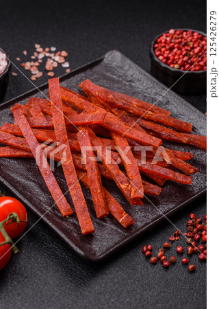 Jerky dried fish sticks with salt and spices Jerky dried fish sticks with salt and spices 125426279