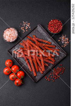 Jerky dried fish sticks with salt and spices 125426282