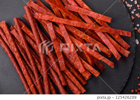 Jerky dried fish sticks with salt and spices 125426289