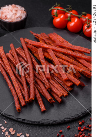 Jerky dried fish sticks with salt and spices 125426291