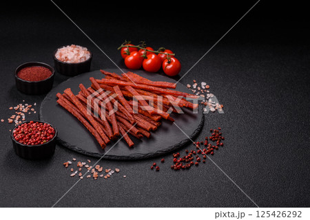 Jerky dried fish sticks with salt and spices 125426292