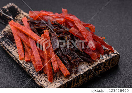 Jerky, dried fish in the form of sticks with salt, spices and herbs Jerky, dried fish in the form of sticks with salt, spices and herbs 125426490