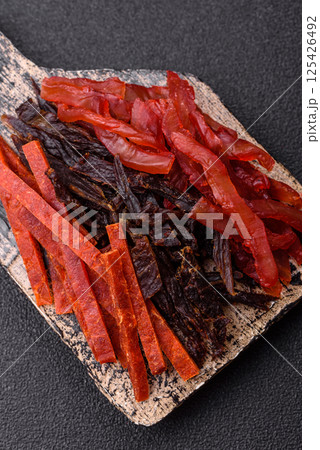 Jerky, dried fish in the form of sticks with salt, spices and herbs Jerky, dried fish in the form of sticks with salt, spices and herbs 125426492