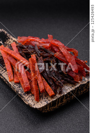 Jerky, dried fish in the form of sticks with salt, spices and herbs Jerky, dried fish in the form of sticks with salt, spices and herbs 125426493