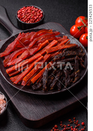Jerky, dried fish in the form of sticks with salt, spices and herbs Jerky, dried fish in the form of sticks with salt, spices and herbs 125426533
