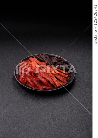 Jerky, dried fish in the form of sticks with salt, spices and herbs Jerky, dried fish in the form of sticks with salt, spices and herbs 125426541