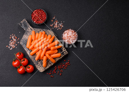 Raw peeled mini baby carrots as an ingredient for preparing a vegetarian food Raw peeled mini baby carrots as an ingredient for preparing a vegetarian food 125426706