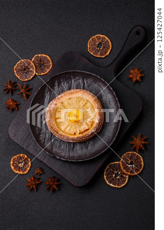 Sweet round tart with pineapple 125427044